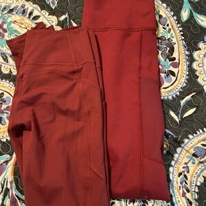 2 pairs of maroon Fabletics leggings
